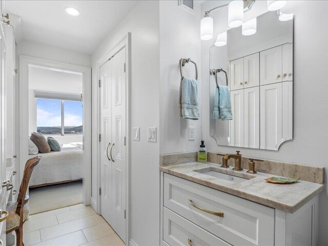 bathroom with tile patterned floors and vanity