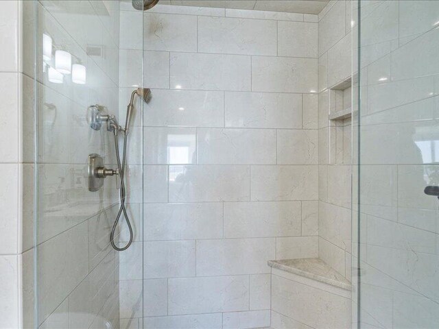 bathroom with a tile shower