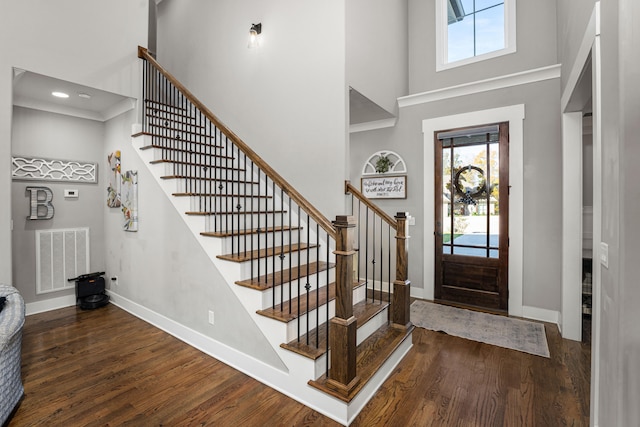 foyer with a high ceiling and dark hardwood / wood-style floors