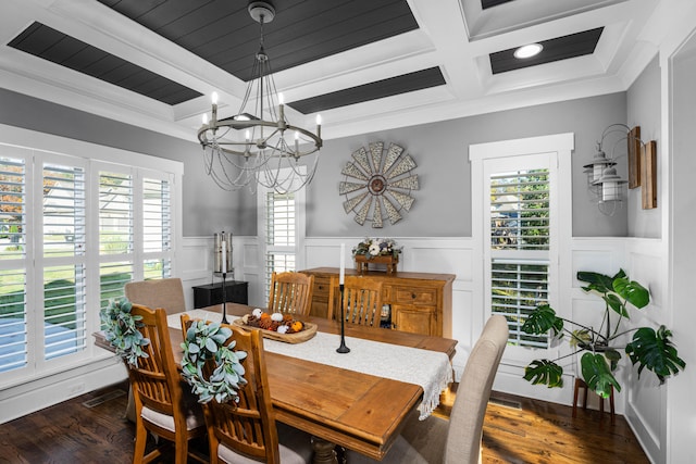 dining area with beam ceiling, a wealth of natural light, dark hardwood / wood-style flooring, and an inviting chandelier