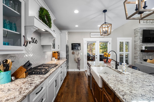 kitchen with sink, hanging light fixtures, dark hardwood / wood-style flooring, white cabinets, and appliances with stainless steel finishes