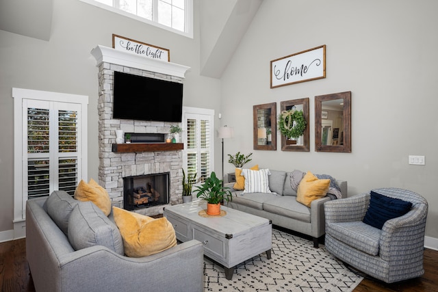 living room featuring a high ceiling, hardwood / wood-style flooring, and plenty of natural light