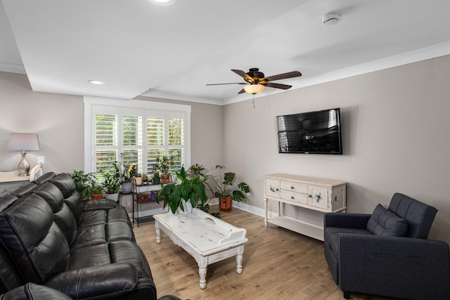 living room with ceiling fan, ornamental molding, and hardwood / wood-style flooring