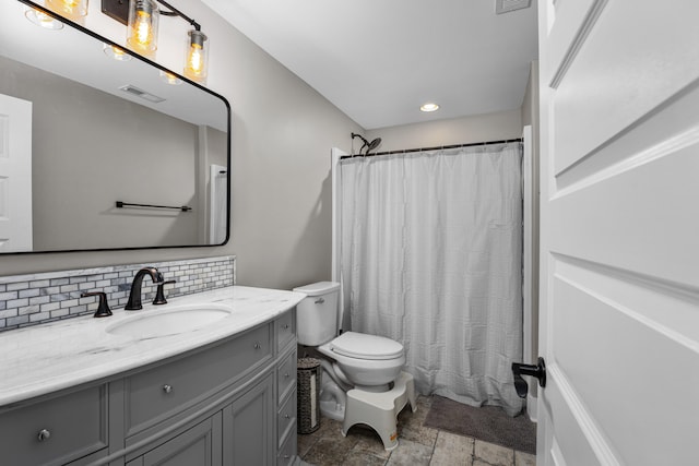 bathroom with a shower with shower curtain, vanity, tasteful backsplash, and toilet