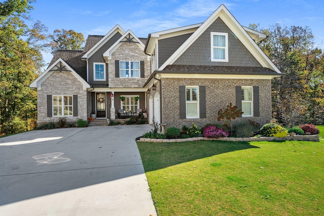 craftsman inspired home with a front lawn