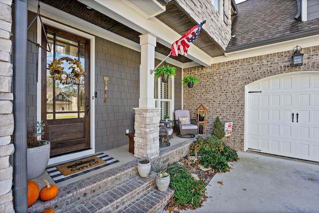 doorway to property featuring covered porch and a garage