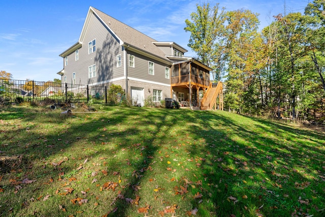 rear view of property featuring a yard and a sunroom