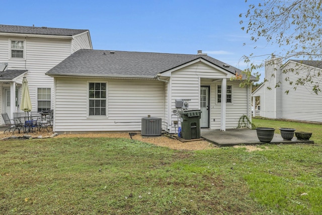 back of property with central air condition unit, a patio, and a yard