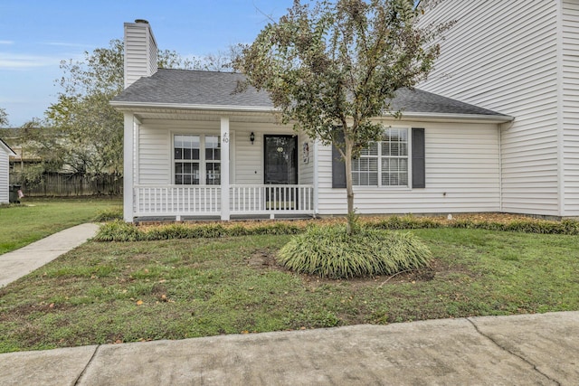 view of front of home with a front yard and a porch