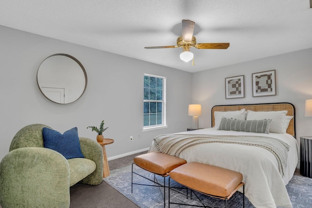 bedroom featuring carpet flooring, a textured ceiling, and ceiling fan