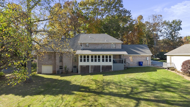 145 County Road 573, Englewood, TN 37329 - back of house featuring a sunroom, a lawn, brick siding, and a garage