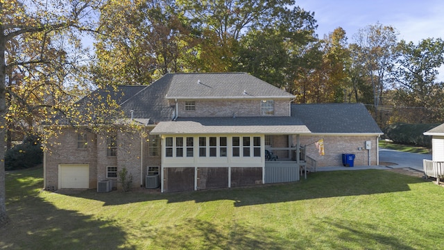 145 County Road 573, Englewood, TN 37329 - back of house with brick siding, a lawn, a sunroom, and an attached garage