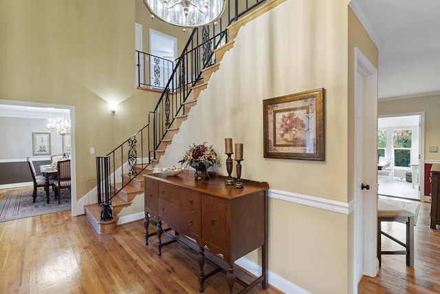 145 County Road 573, Englewood, TN 37329 - stairway featuring a chandelier, wood finished floors, crown molding, and a high ceiling