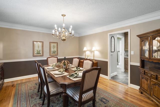 145 County Road 573, Englewood, TN 37329 - dining area with a chandelier, a textured ceiling, light wood-style flooring, and ornamental molding