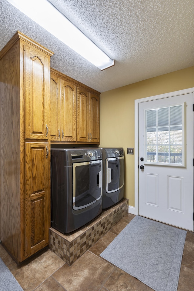 145 County Road 573, Englewood, TN 37329 - laundry room with washer and dryer, cabinet space, and a textured ceiling