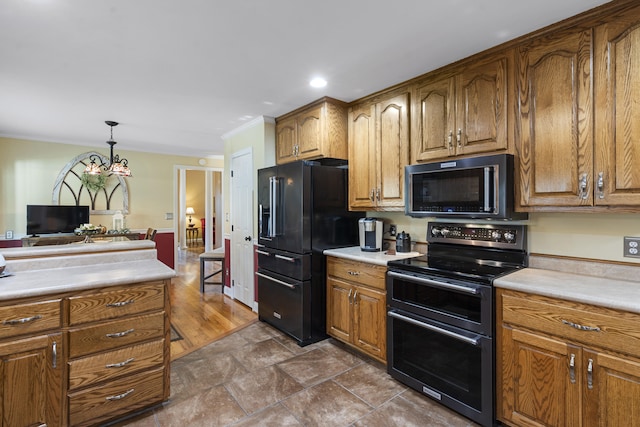 145 County Road 573, Englewood, TN 37329 - kitchen featuring black appliances, light countertops, pendant lighting, brown cabinets, and recessed lighting
