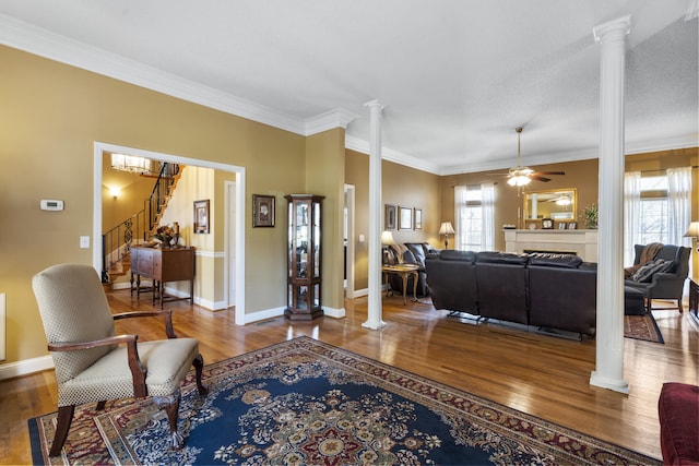 145 County Road 573, Englewood, TN 37329 - living area featuring ornate columns, wood finished floors, stairway, ornamental molding, and ceiling fan