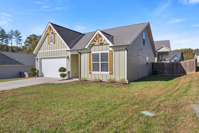 view of front facade featuring a front yard, a garage, and central air condition unit