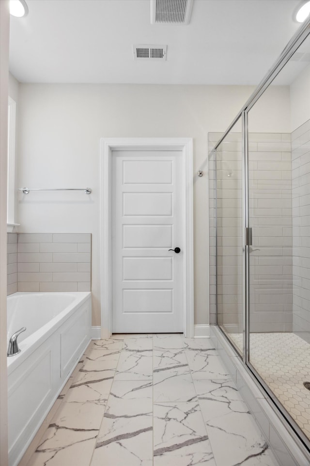 bathroom featuring independent shower and bath