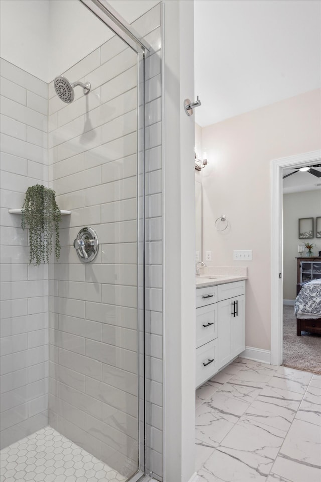 bathroom featuring tiled shower and vanity