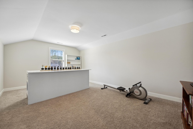 unfurnished office featuring light carpet and lofted ceiling