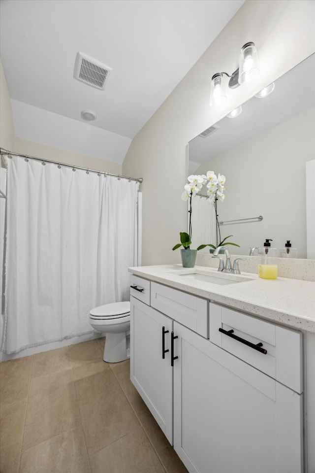 bathroom with tile patterned flooring, vanity, and toilet