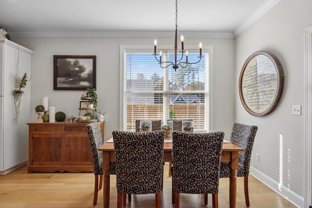 dining room with ornamental molding, light hardwood / wood-style flooring, and an inviting chandelier