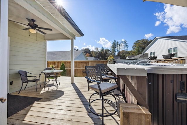 wooden terrace featuring an outdoor bar and ceiling fan