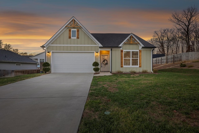 view of front of property featuring fence, an attached garage, a front yard, board and batten siding, and driveway