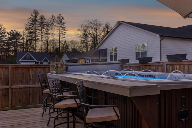 deck at dusk with exterior bar