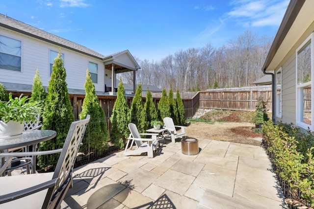 view of patio / terrace with an outdoor fire pit and a fenced backyard