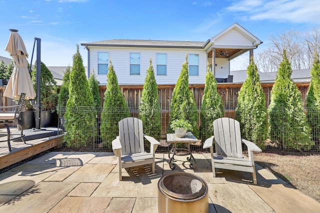 view of patio featuring an outdoor fire pit and fence