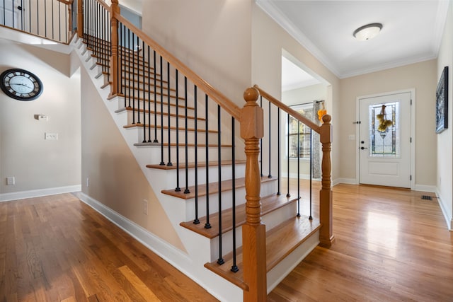 entryway featuring hardwood / wood-style floors and ornamental molding