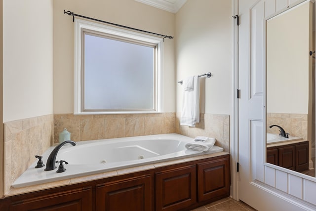 bathroom featuring tile patterned floors, crown molding, and a tub