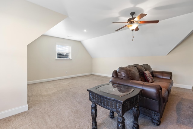 sitting room with ceiling fan, light colored carpet, and lofted ceiling