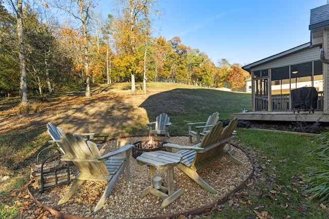 view of yard with a fire pit and a sunroom