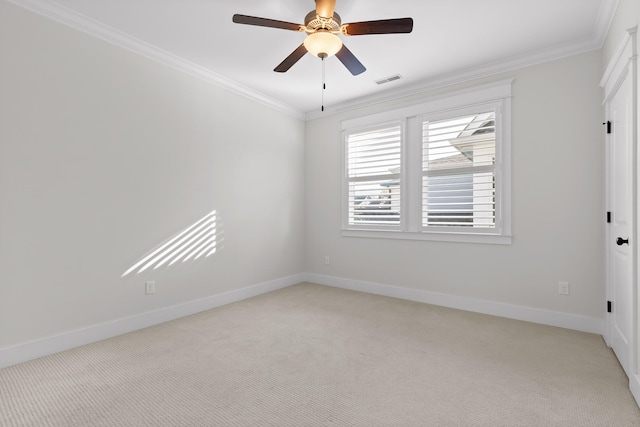 carpeted empty room with ceiling fan and crown molding