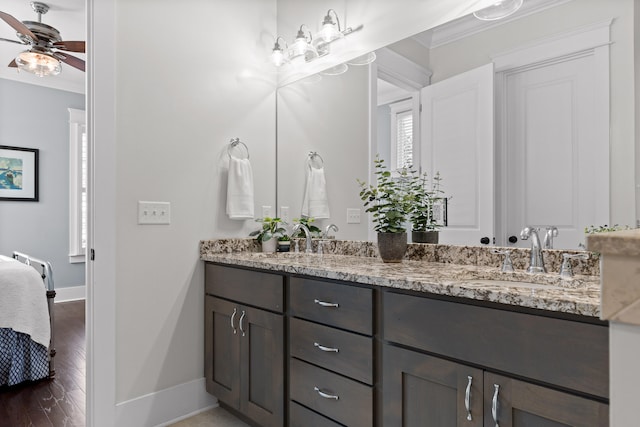 bathroom featuring ceiling fan, hardwood / wood-style floors, vanity, and crown molding