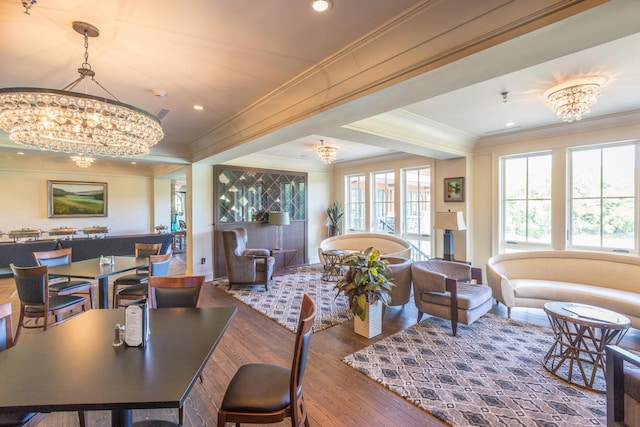 dining area featuring wood-type flooring, an inviting chandelier, and crown molding