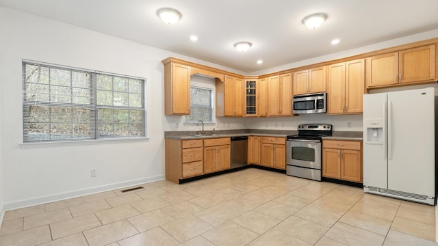 kitchen featuring sink, light tile patterned floors, and stainless steel appliances