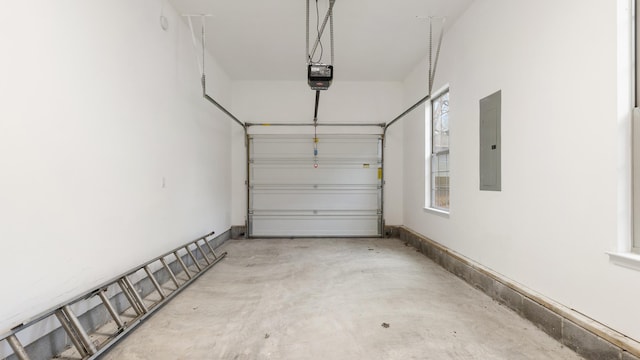 garage with a garage door opener and electric panel