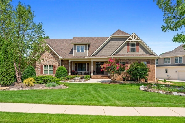 4014 Hawks Way NE, Huntsville, AL 35811 - craftsman-style house featuring a porch, a front yard, and brick siding