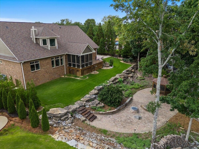 4014 Hawks Way NE, Huntsville, AL 35811 - back of house with a sunroom, brick siding, roof with shingles, and a yard