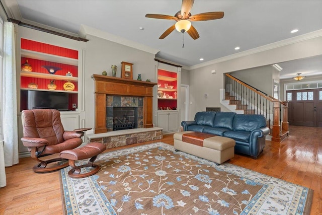 4014 Hawks Way NE, Huntsville, AL 35811 - living room with crown molding, stairs, wood finished floors, a fireplace, and a ceiling fan