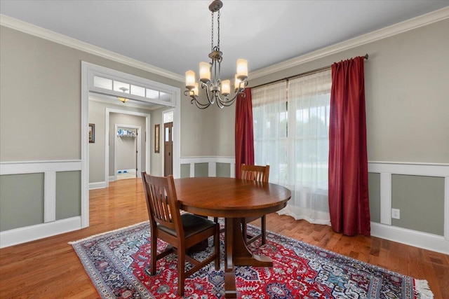 4014 Hawks Way NE, Huntsville, AL 35811 - dining room with crown molding, a chandelier, and wood finished floors