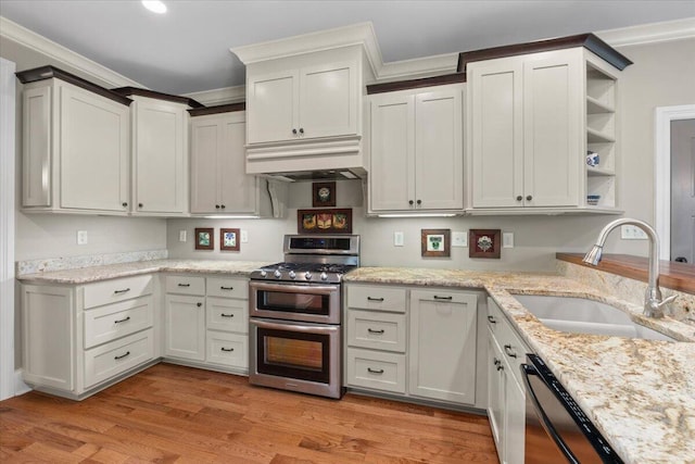 4014 Hawks Way NE, Huntsville, AL 35811 - kitchen featuring stainless steel appliances, open shelves, custom exhaust hood, crown molding, and light wood-style floors