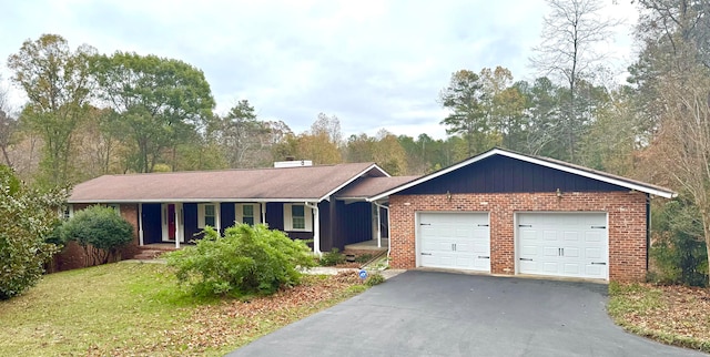 single story home with a garage and a front lawn