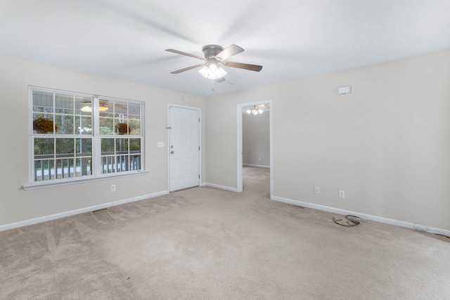 spare room with ceiling fan and light colored carpet