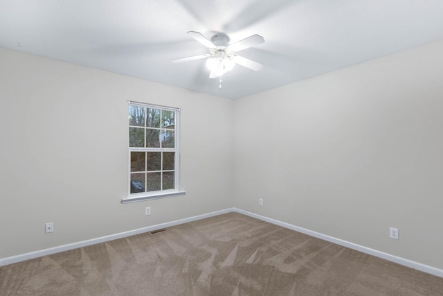 empty room featuring carpet flooring and ceiling fan