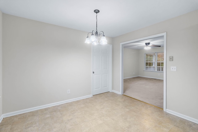 carpeted empty room featuring ceiling fan with notable chandelier